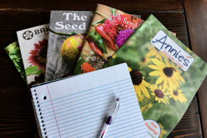 heirloom seed catalogs on a wooden table
