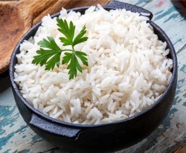 a bowl of white rice with parsley