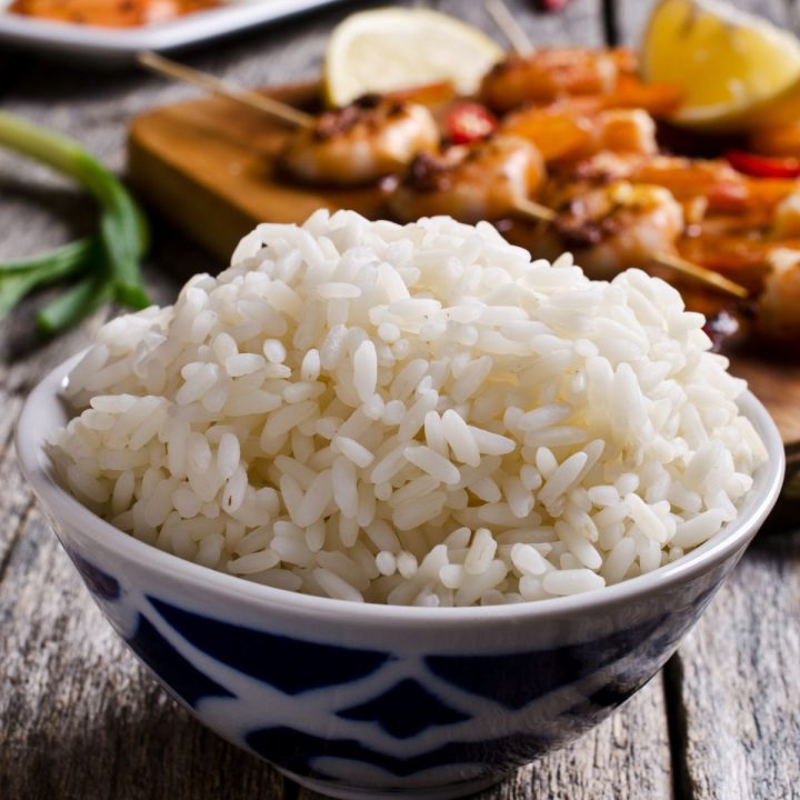 bowl of rice with food in the background