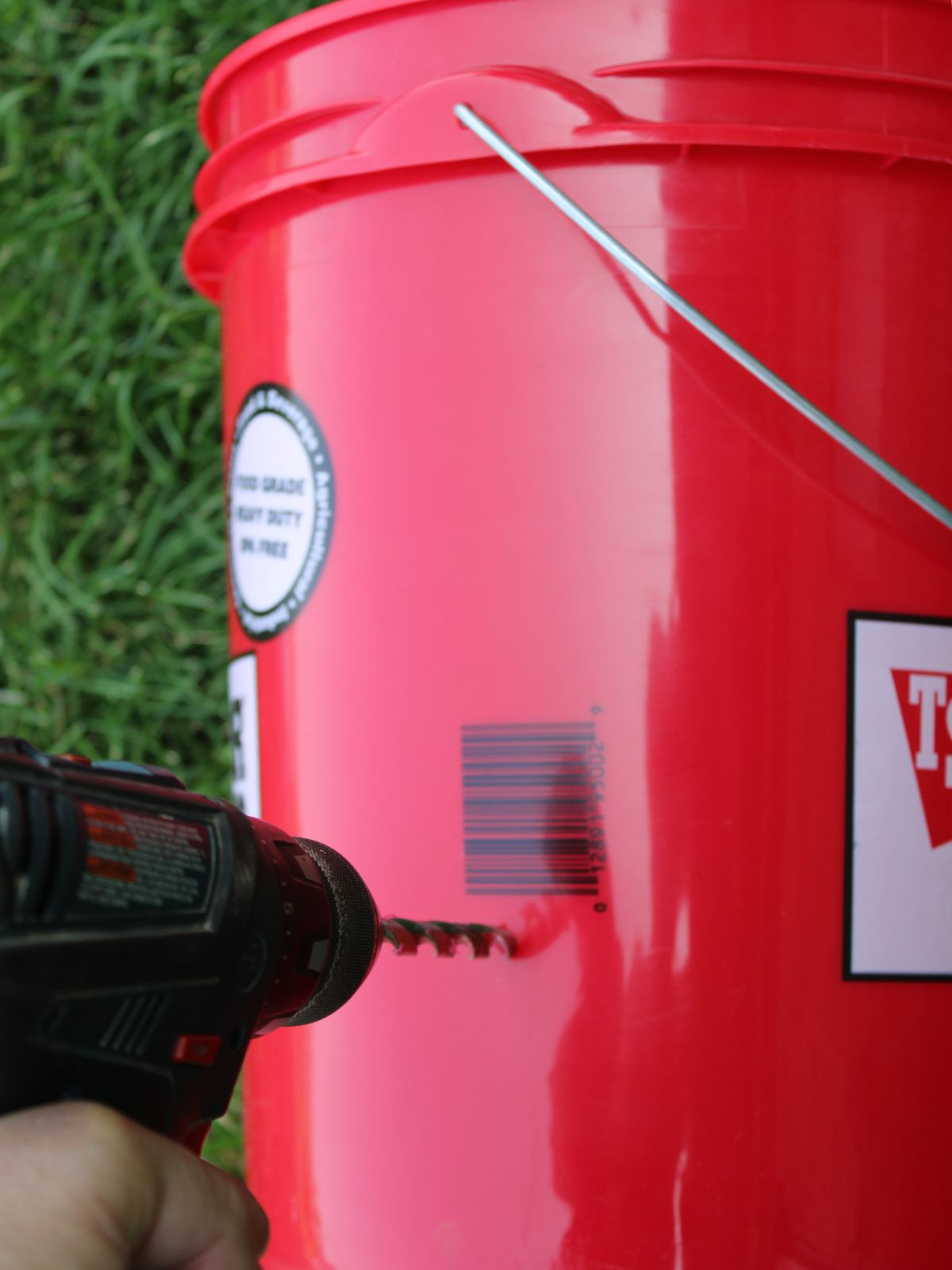 Drilling into a red bucket