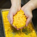 Freeze dried egg flakes in a lady's hand.